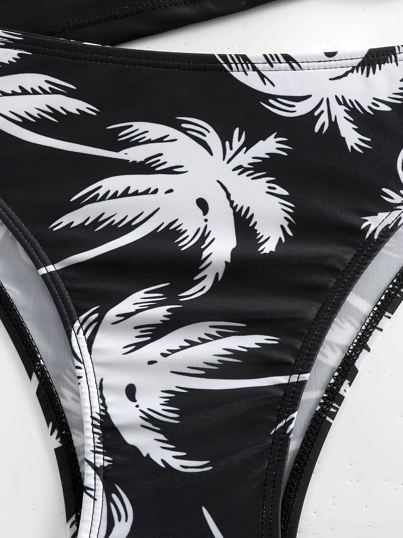Women's black split bikini set with coconut print and tie up